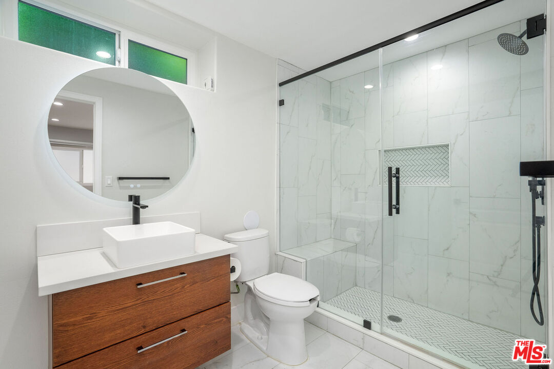 5923 Etiwanda Avenue, Unit 106 Tarzana, CA 91356 - Photo 19 of 27 a bathroom with a sink toilet and shower