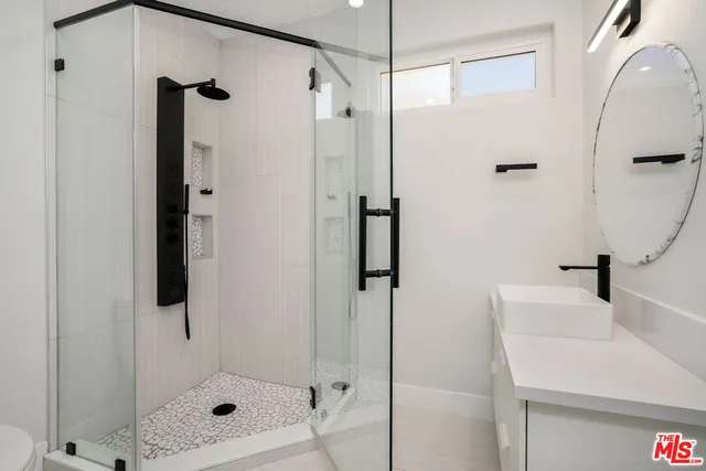 a bathroom with a shower and a sink