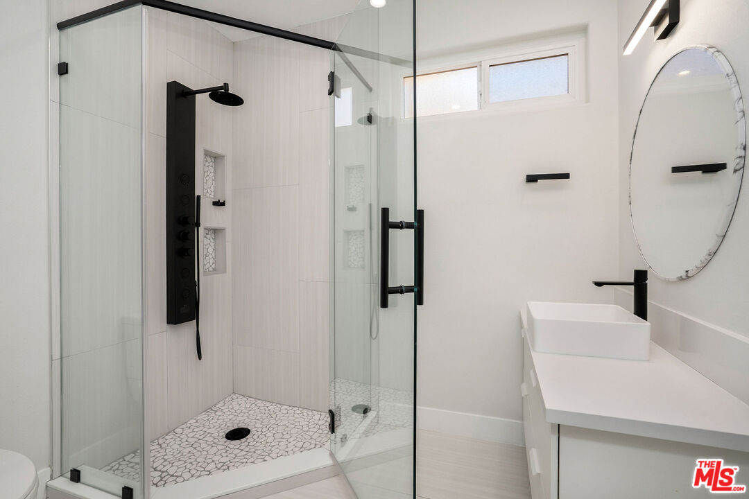 5923 Etiwanda Avenue, Unit 106 Tarzana, CA 91356 - Photo 21 of 27 a bathroom with a shower and a sink