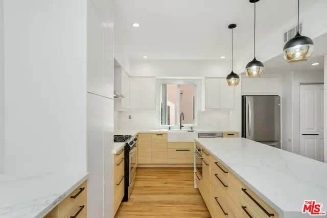 a spacious bathroom with a double vanity sink and a large mirror