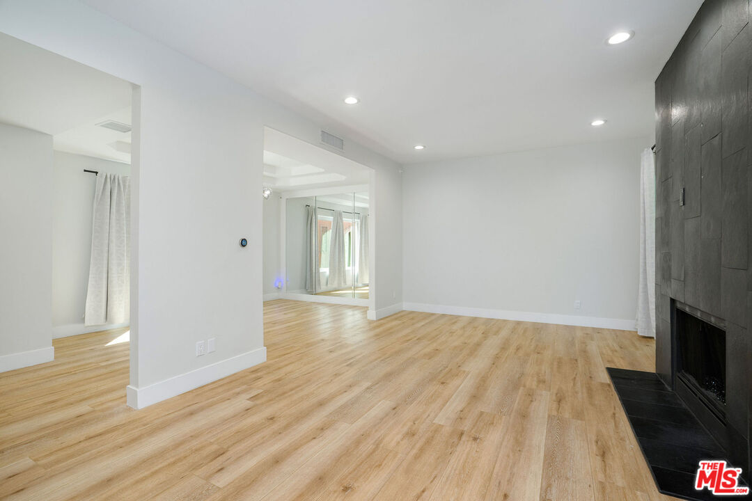 5923 Etiwanda Avenue, Unit 106 Tarzana, CA 91356 - Photo 5 of 27 a view of empty room with wooden floor and fireplace
