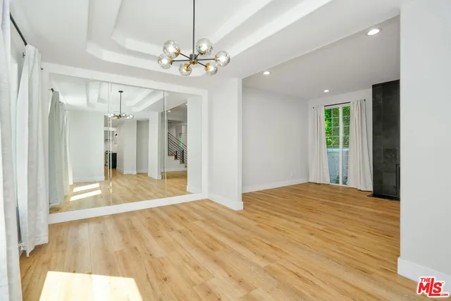 a view of an empty room and wooden floor