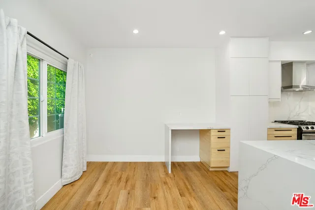 a bedroom with a bed and a view of kitchen