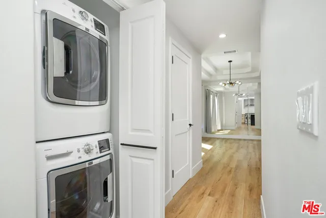 a view of a hallway with washer and dryer