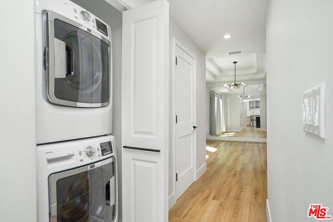 5923 Etiwanda Avenue, Unit 106 Tarzana, CA 91356 - Photo 10 of 27 a view of a hallway with washer and dryer