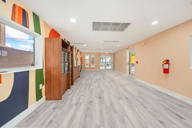 a view of a room with wooden floor