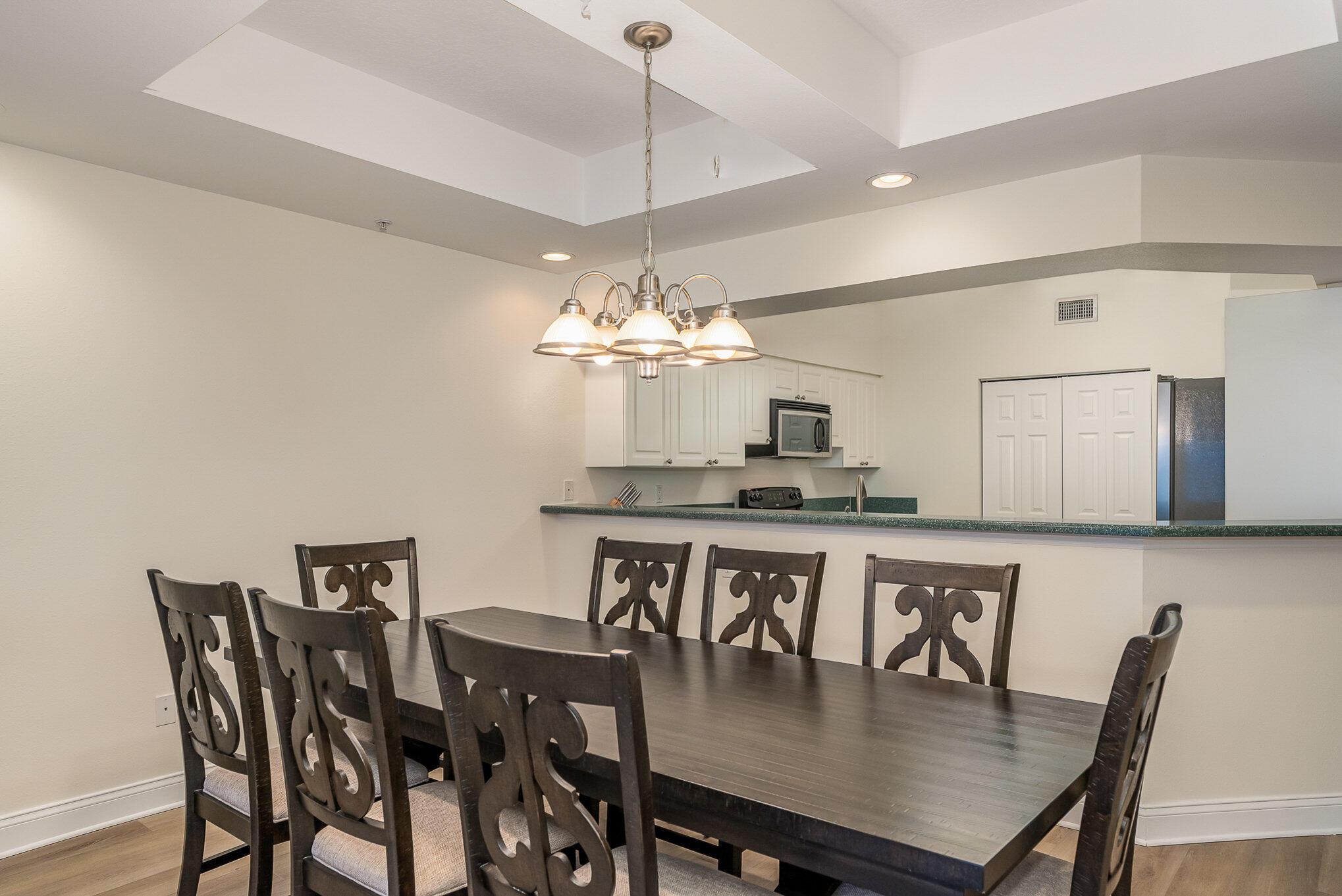 125 Pulsipher Avenue, Unit 402 Cocoa Beach, FL 32931 - Photo 11 of 34 a view of a dining room with furniture and chandelier