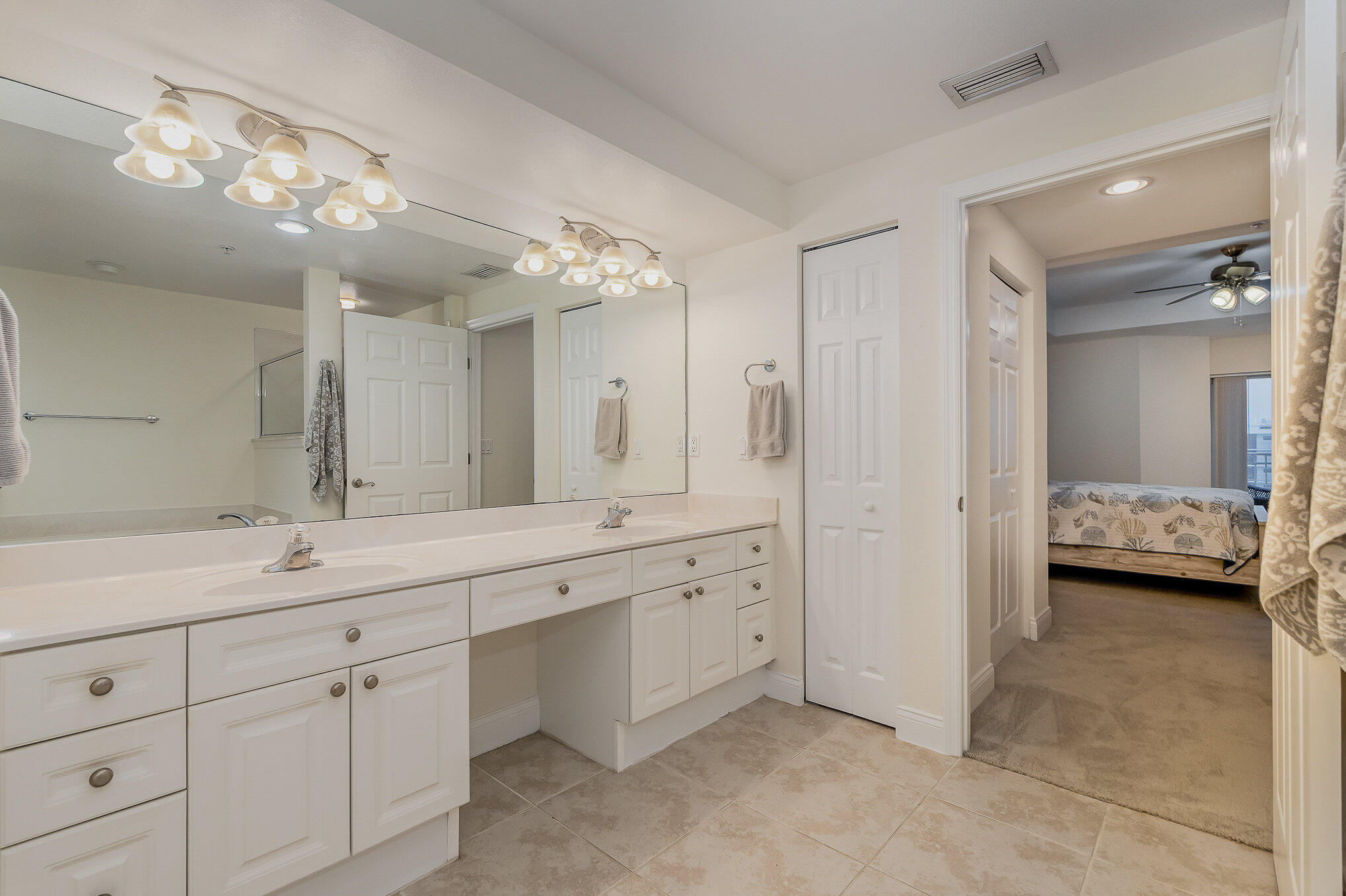 125 Pulsipher Avenue, Unit 402 Cocoa Beach, FL 32931 - Photo 21 of 34 a spacious bathroom with a double vanity sink mirror and double