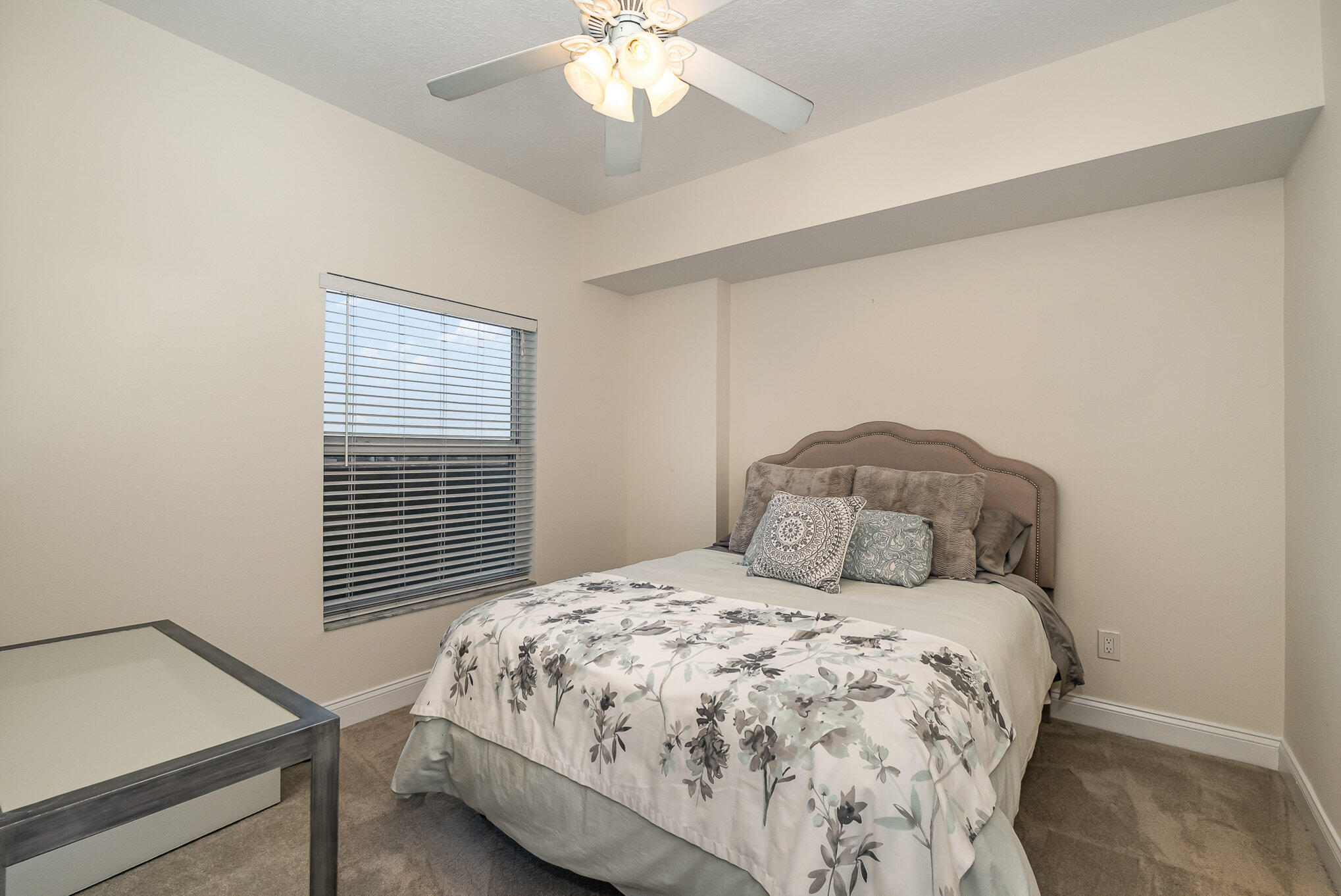 125 Pulsipher Avenue, Unit 402 Cocoa Beach, FL 32931 - Photo 23 of 34 a bedroom with a bed and a window