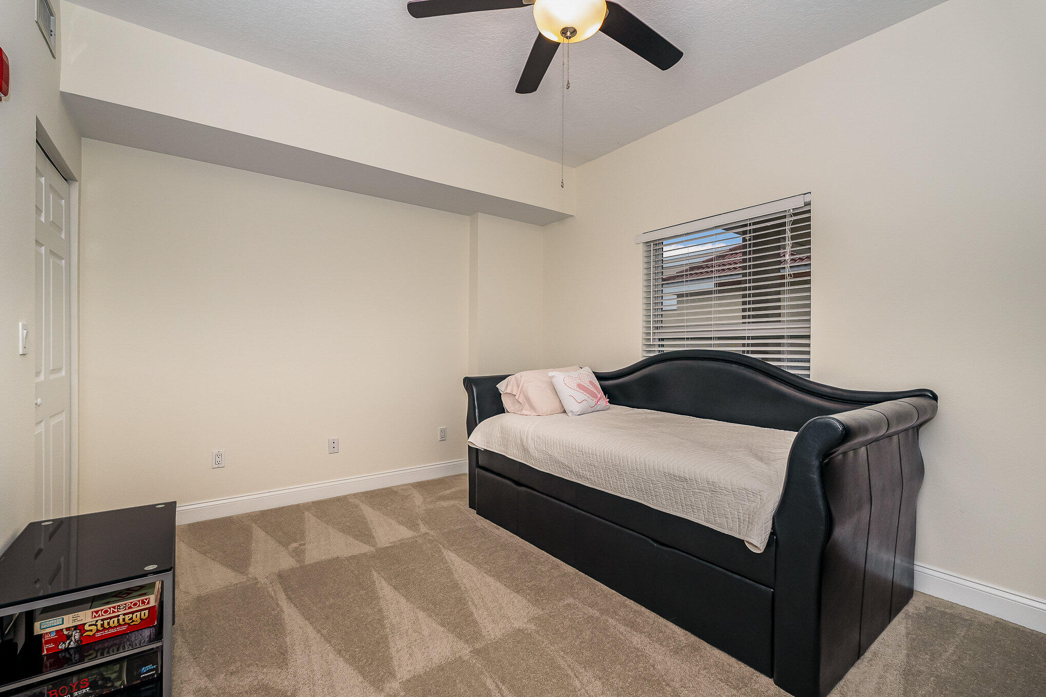 125 Pulsipher Avenue, Unit 402 Cocoa Beach, FL 32931 - Photo 26 of 34 a bedroom with a bed and a television