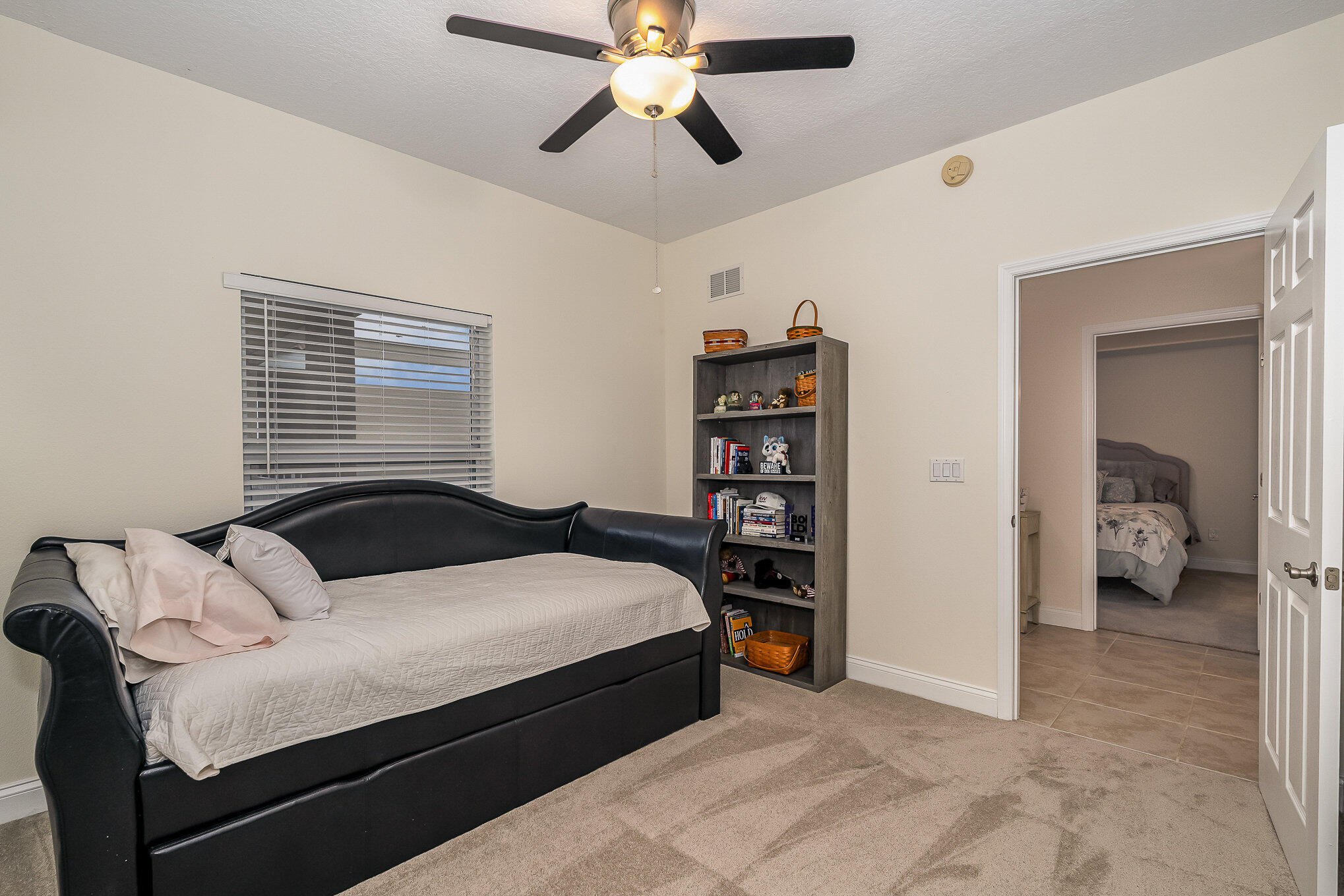 125 Pulsipher Avenue, Unit 402 Cocoa Beach, FL 32931 - Photo 27 of 34 a bedroom with a bed and a chandelier