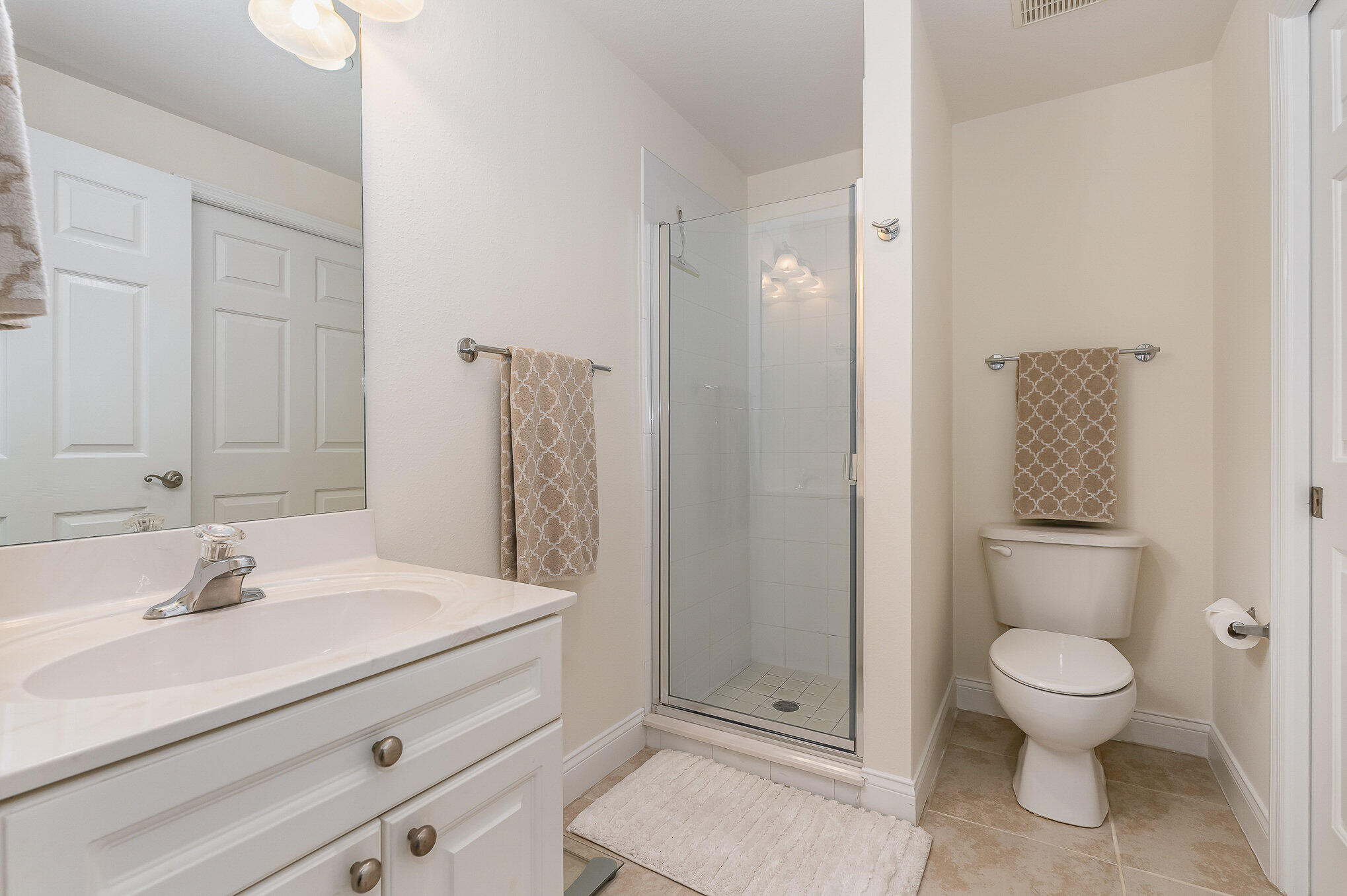 125 Pulsipher Avenue, Unit 402 Cocoa Beach, FL 32931 - Photo 29 of 34 a bathroom with a sink a toilet and shower