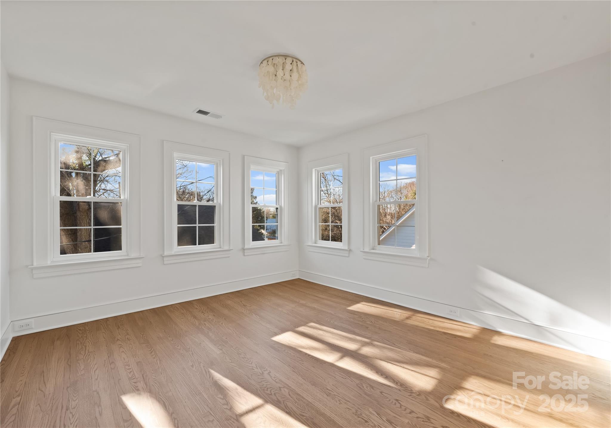 3415 Holt Street Charlotte, NC 28205 - Photo 42 of 48 a view of an empty room with a window and wooden floor