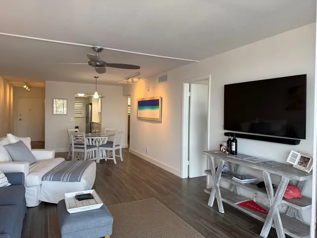 a bedroom with a bed and painting on the wall