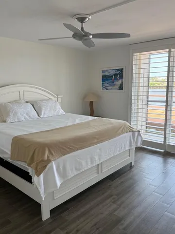 a bathroom with a sink a toilet a mirror and a glass door shower