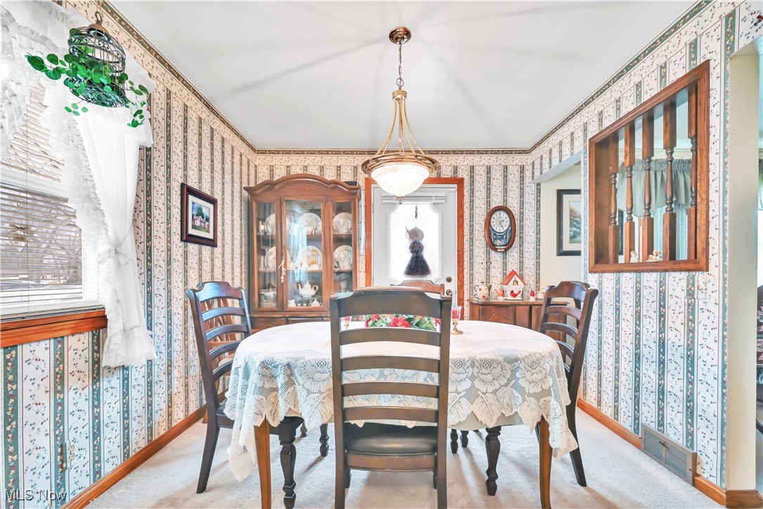 376 Johnson Plank Road Warren, OH 44481 - Photo 6 of 28 Dining area with wallpapered walls and carpet