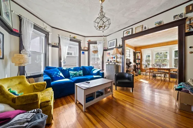 a living room with a flat screen tv and a floor to ceiling window