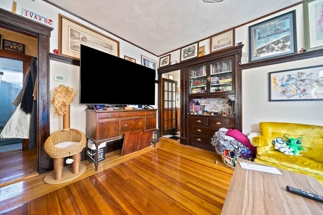 a living room with furniture a rug and a chandelier