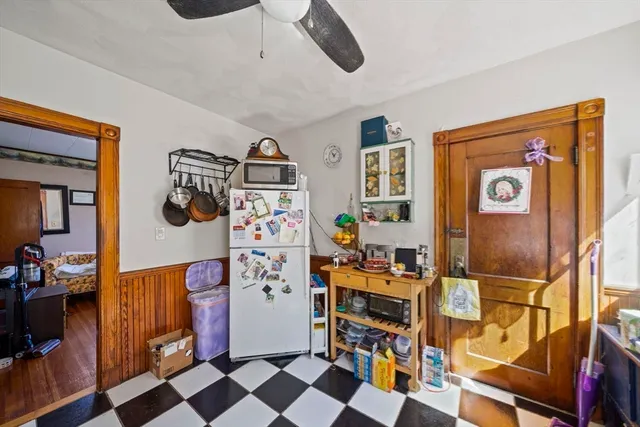 a kitchen with stainless steel appliances a stove a sink and a refrigerator with wooden floor