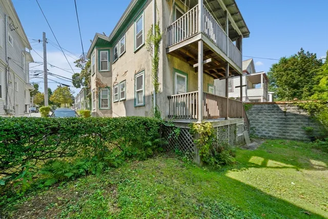 a view of a house with brick walls and wooden fence
