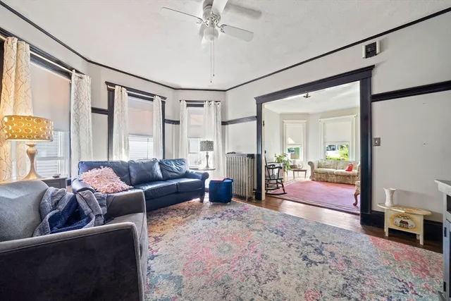 a living room with furniture and a wooden floor