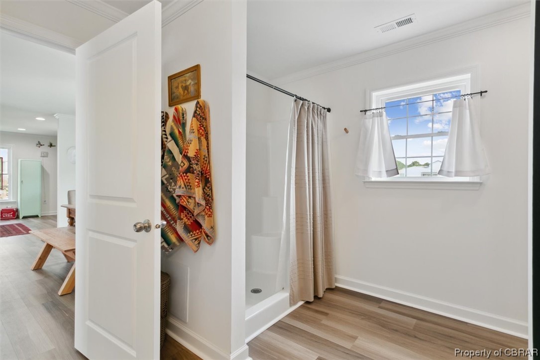 1978 Cross Road Hayes, VA 23072 - Photo 24 of 46 Bathroom with hardwood floors, a wealth of natural light, shower curtain, and a shower