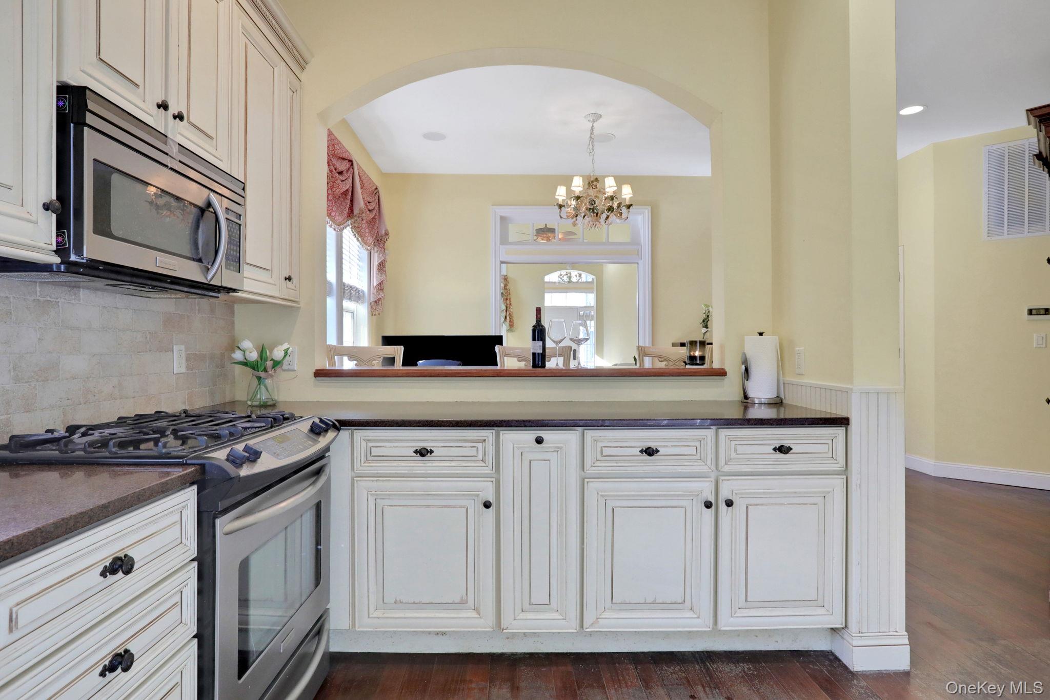 26 Reunion Road Rye Brook, NY 10573 - Photo 12 of 48 a kitchen with granite countertop white cabinets and stainless steel appliances