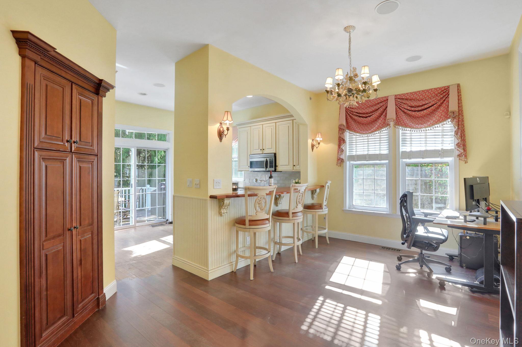 26 Reunion Road Rye Brook, NY 10573 - Photo 14 of 48 a view of a dining room with furniture a chandelier and wooden floor