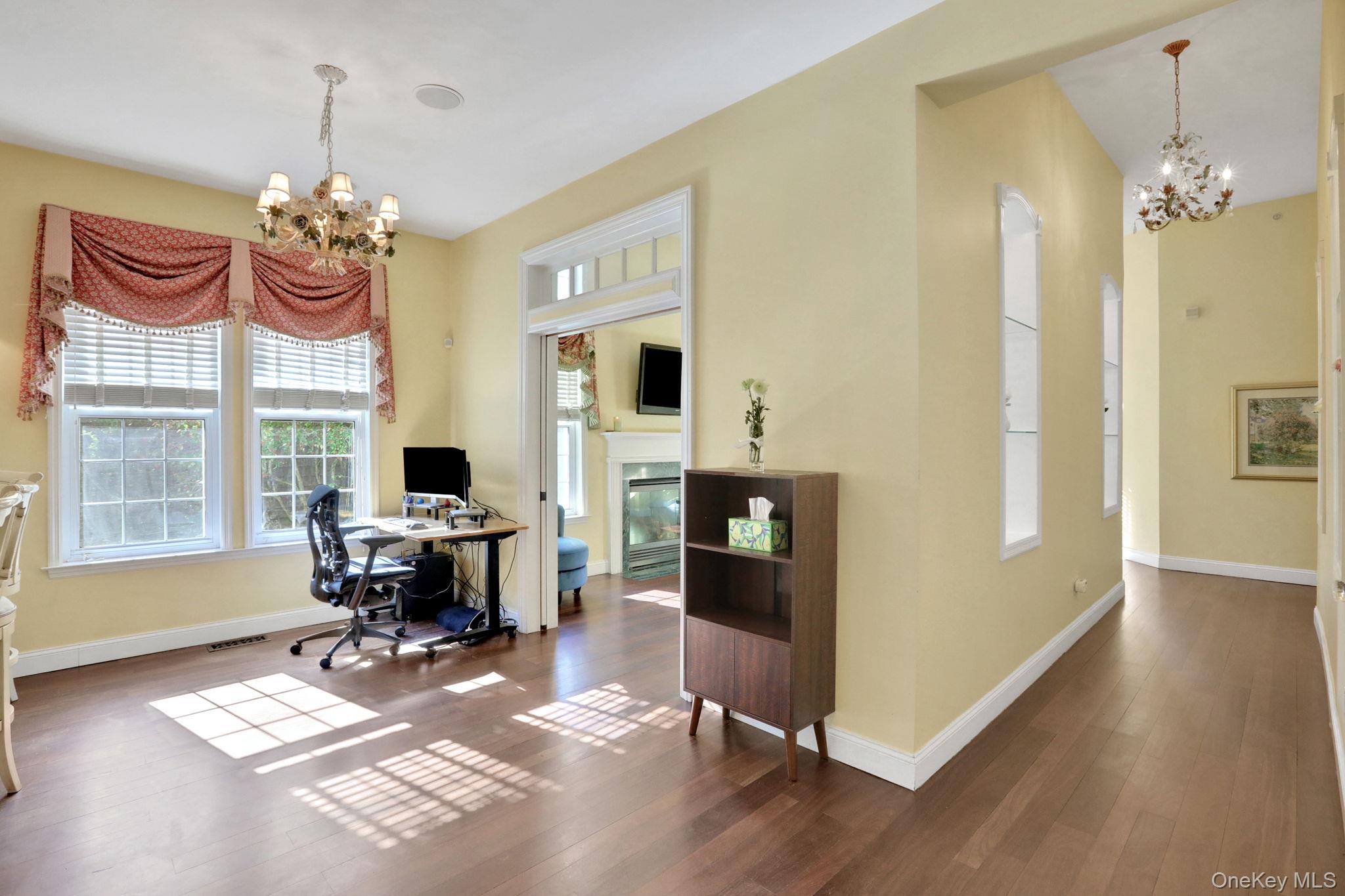 26 Reunion Road Rye Brook, NY 10573 - Photo 15 of 48 a view of a dining room with furniture a chandelier and wooden floor