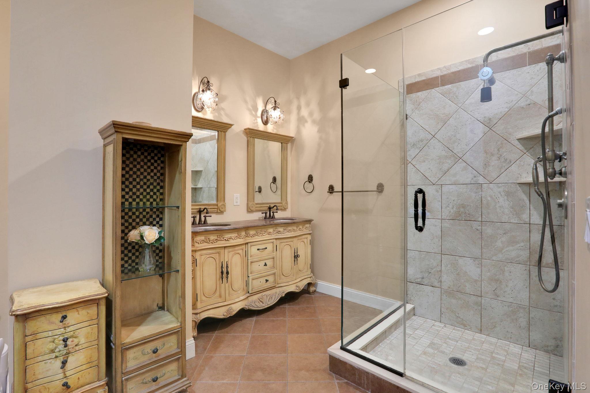 26 Reunion Road Rye Brook, NY 10573 - Photo 18 of 48 a bathroom with a granite countertop sink a mirror and a shower