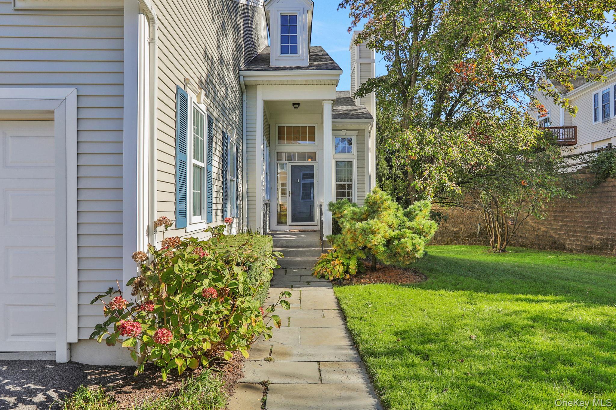 26 Reunion Road Rye Brook, NY 10573 - Photo 2 of 48 a view of a pathway both side of the house