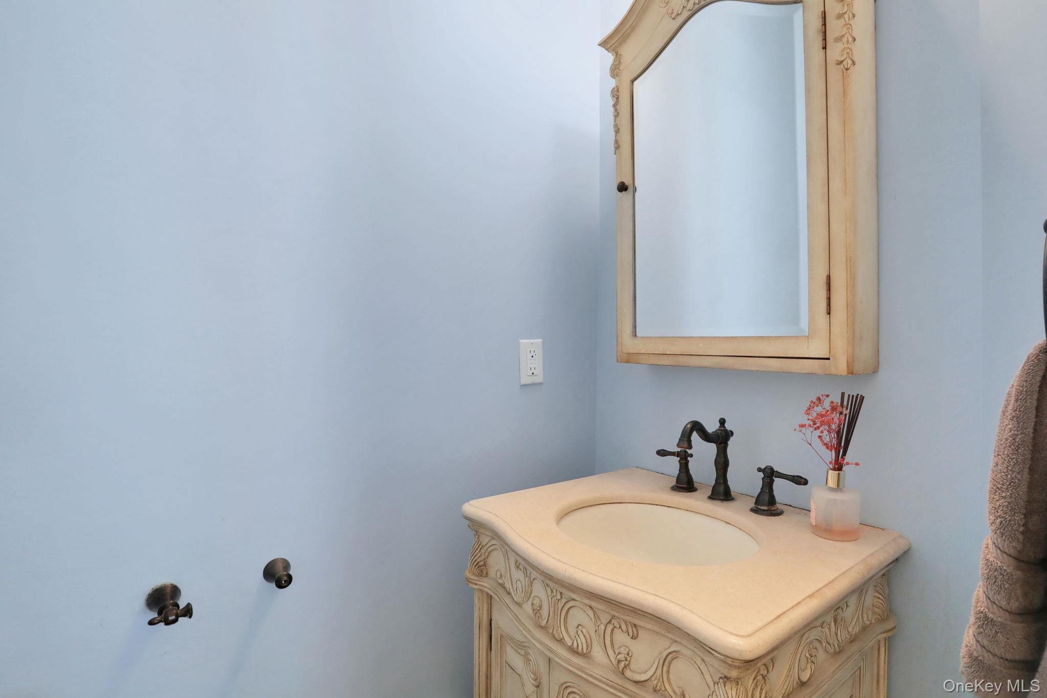 26 Reunion Road Rye Brook, NY 10573 - Photo 24 of 48 a bathroom with a sink and a mirror