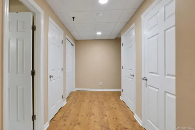 a view of hallway with a large mirror and a shower