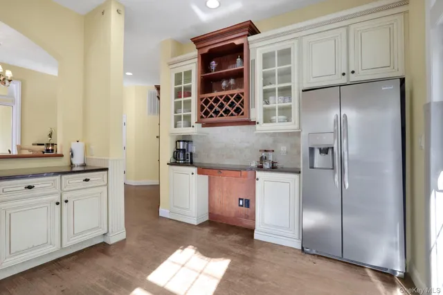a kitchen with stainless steel appliances granite countertop a refrigerator and a stove