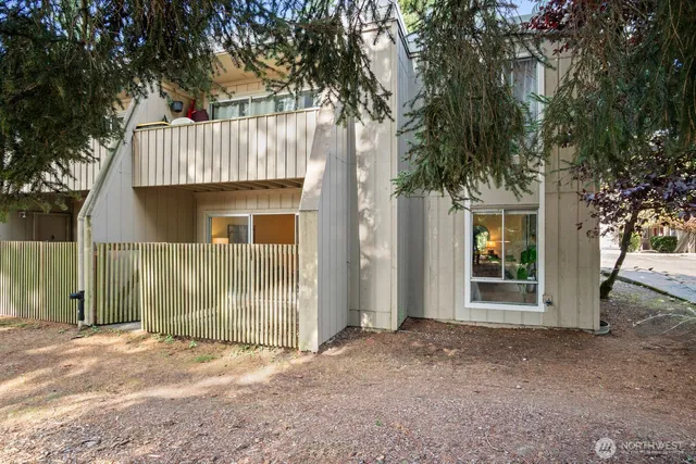 a front view of a house with a tree