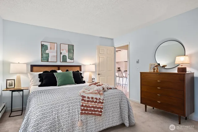 a bedroom with a bed and a large window