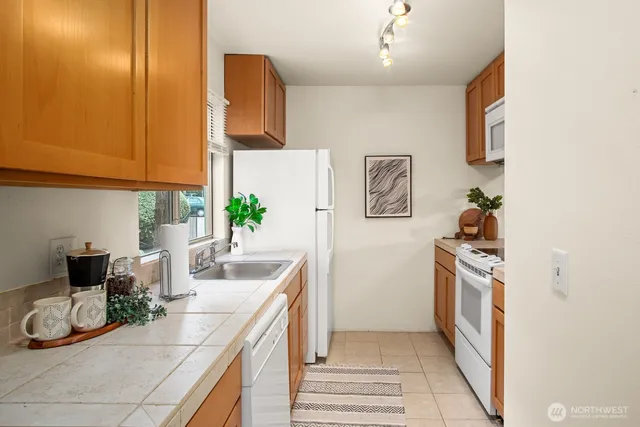 a view of kitchen with appliances and cabinets