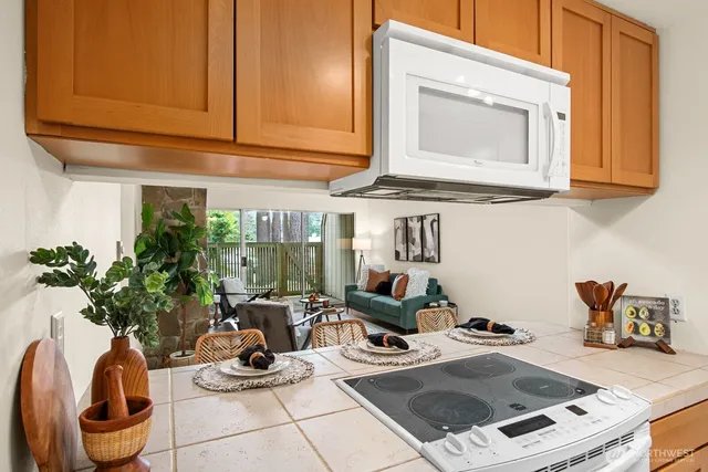 a kitchen with a refrigerator sink and cabinets