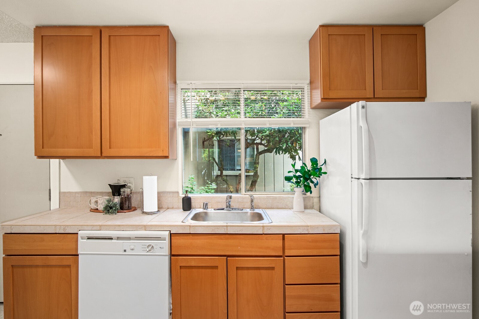 4803 180th Street Southwest, Unit A101 Lynnwood, WA 98037 - Photo 6 of 24 a kitchen with a refrigerator sink and cabinets
