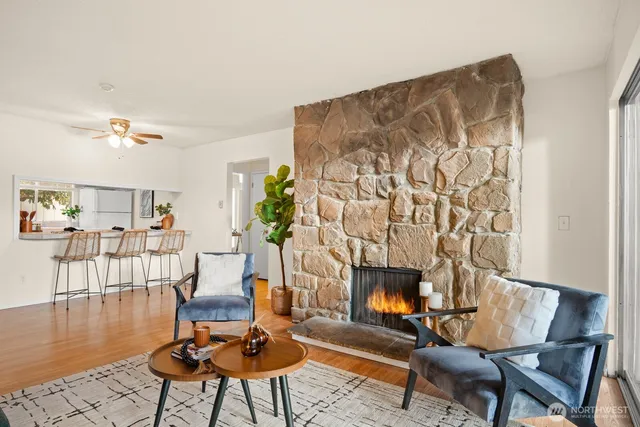 a living room with furniture and a floor to ceiling window