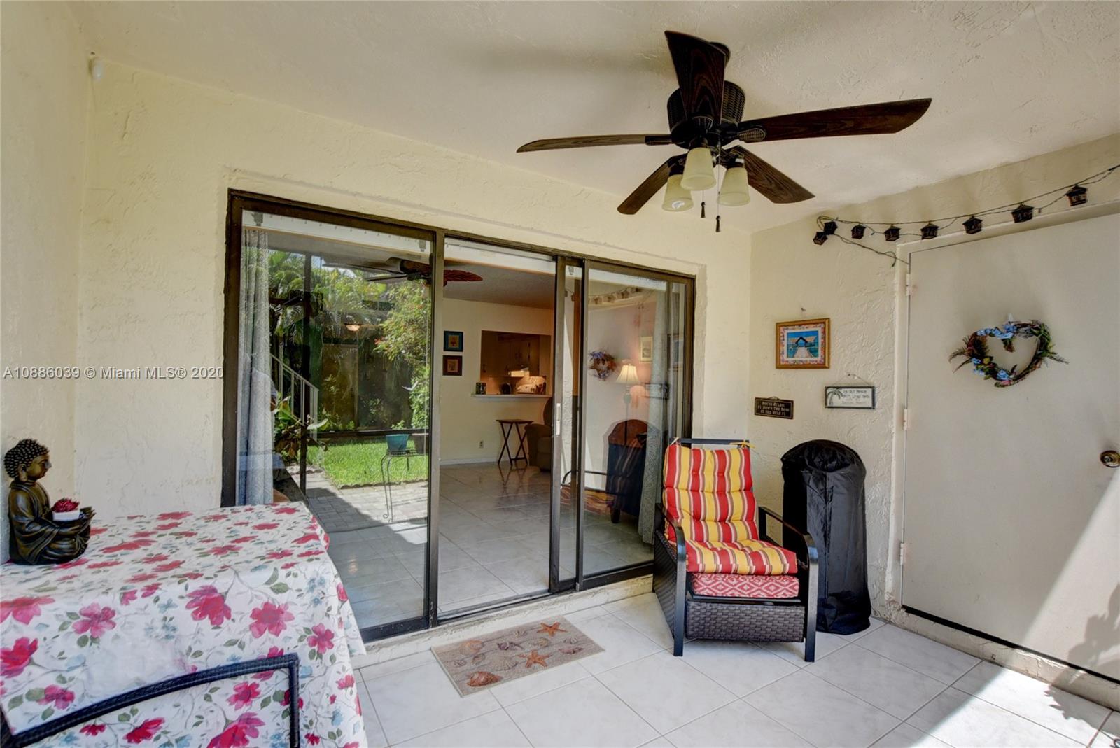 22415 Southwest 61st Way, Unit 107 Boca Raton, FL 33428 - Photo 7 of 48 a bedroom with a bed and a chandelier