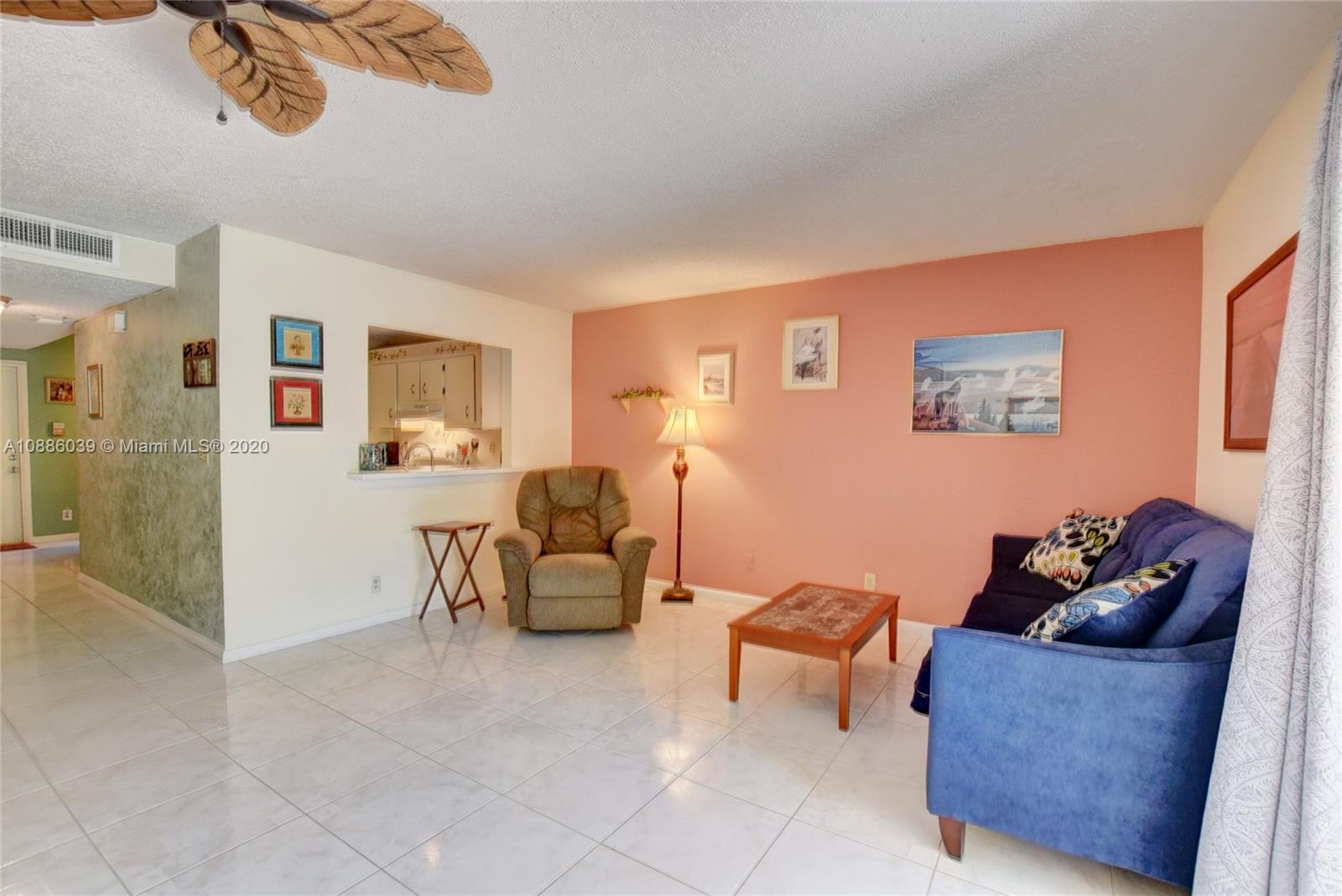 22415 Southwest 61st Way, Unit 107 Boca Raton, FL 33428 - Photo 9 of 48 a living room with furniture and a window