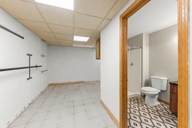 a bathroom with a toilet and a shower