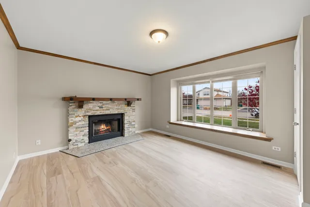 a view of an empty room with a fireplace and a window