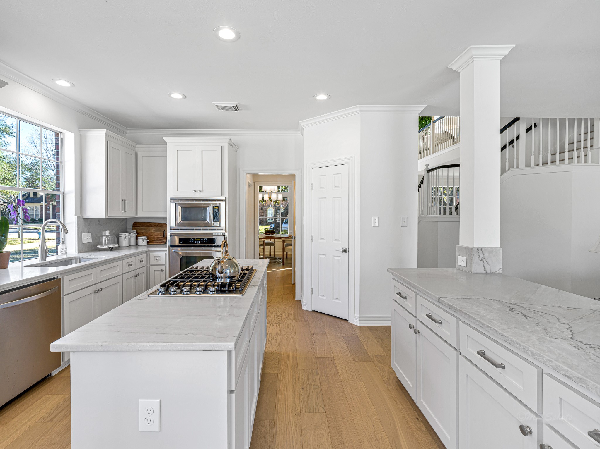 1910 Landon Point Circle Katy, TX 77450 - Photo 16 of 37 Another view of the kitchen with the formal dining room and staircase in the background. Stainless steel sink and appliances.