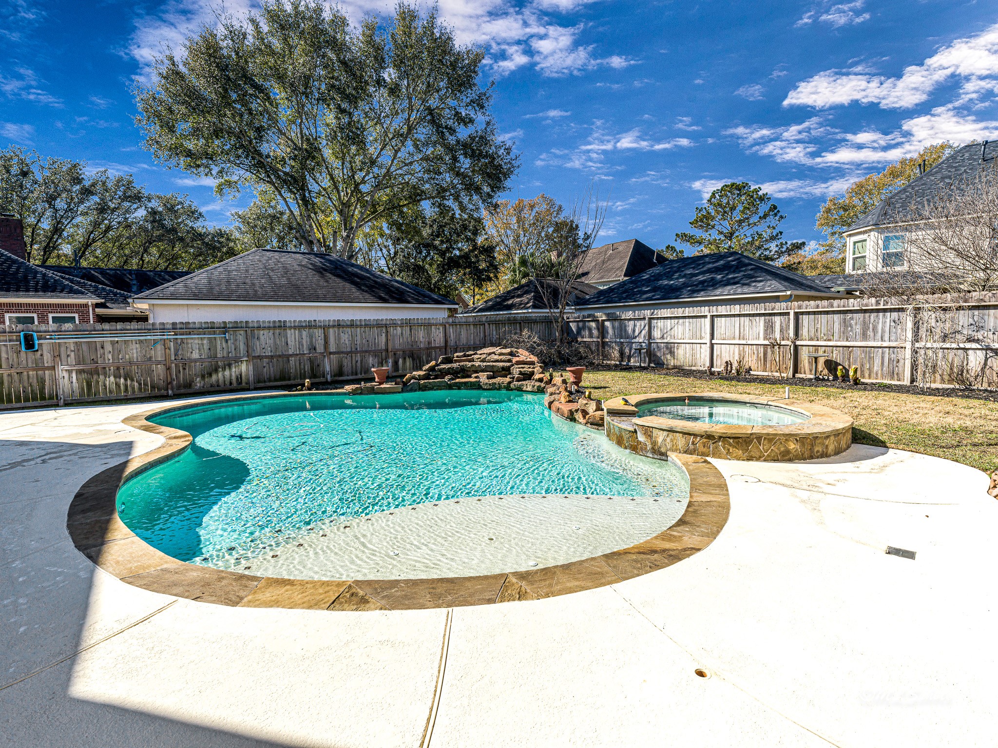 1910 Landon Point Circle Katy, TX 77450 - Photo 32 of 37 Wonderful pool has several water fall features, heated, lots of umbrella stand holes to provide shade all around the pool.