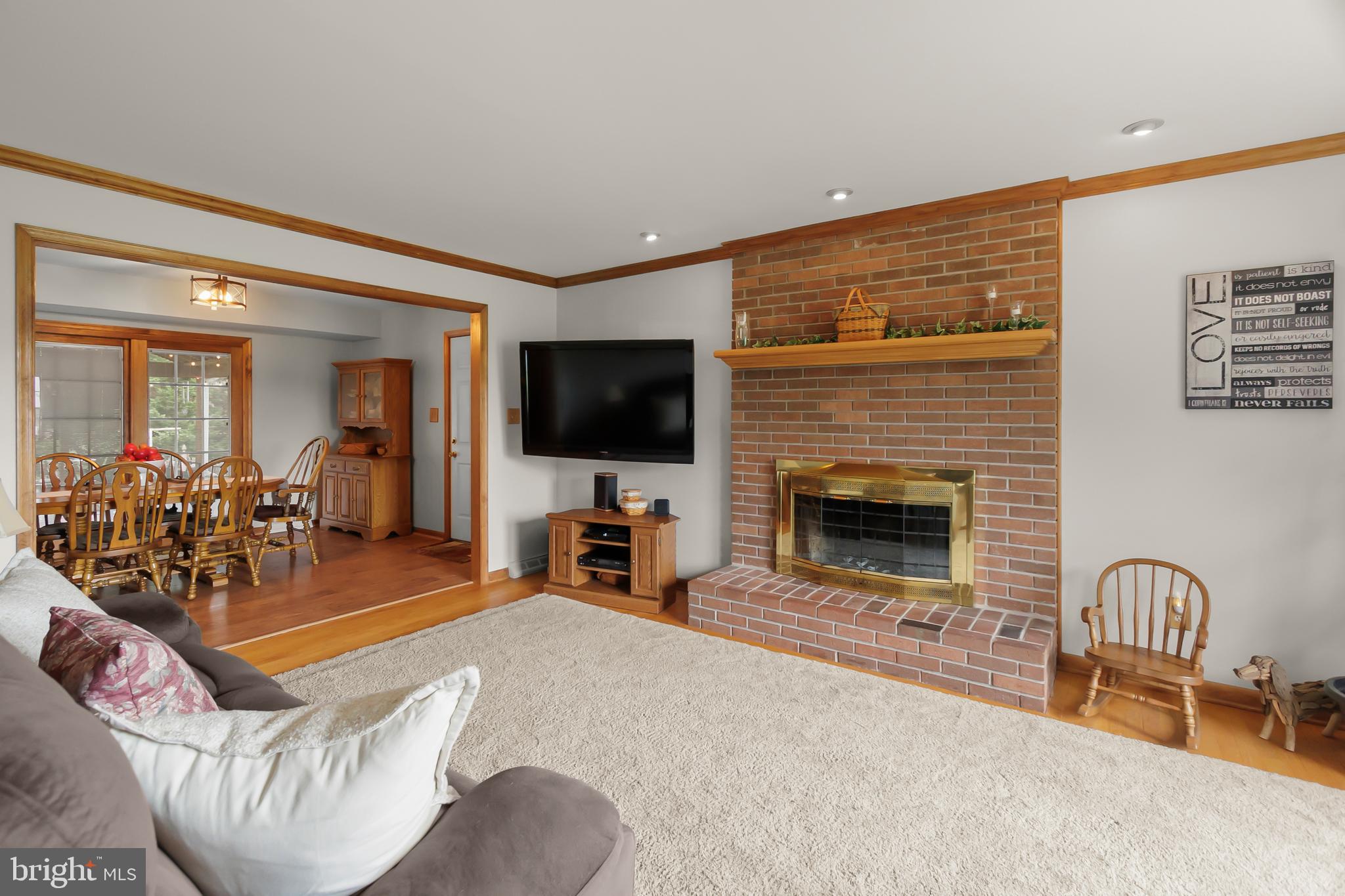 8 Wortham Court Bear, DE 19701 - Photo 11 of 71 a living room with furniture a flat screen tv and a fireplace