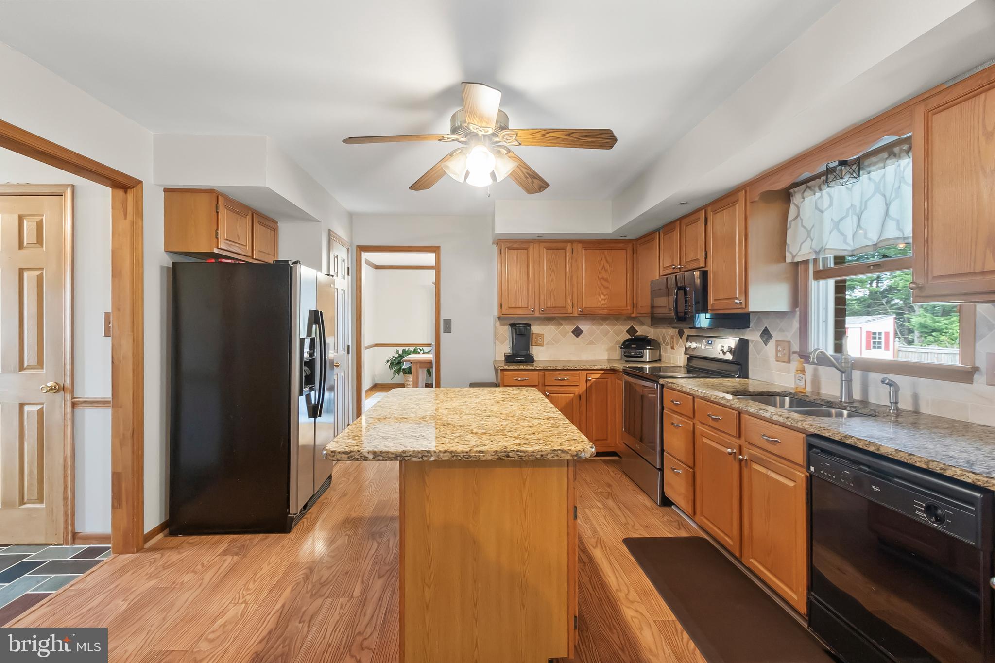 8 Wortham Court Bear, DE 19701 - Photo 16 of 71 a kitchen with stainless steel appliances granite countertop a refrigerator a sink dishwasher a stove and white countertops with wooden floor