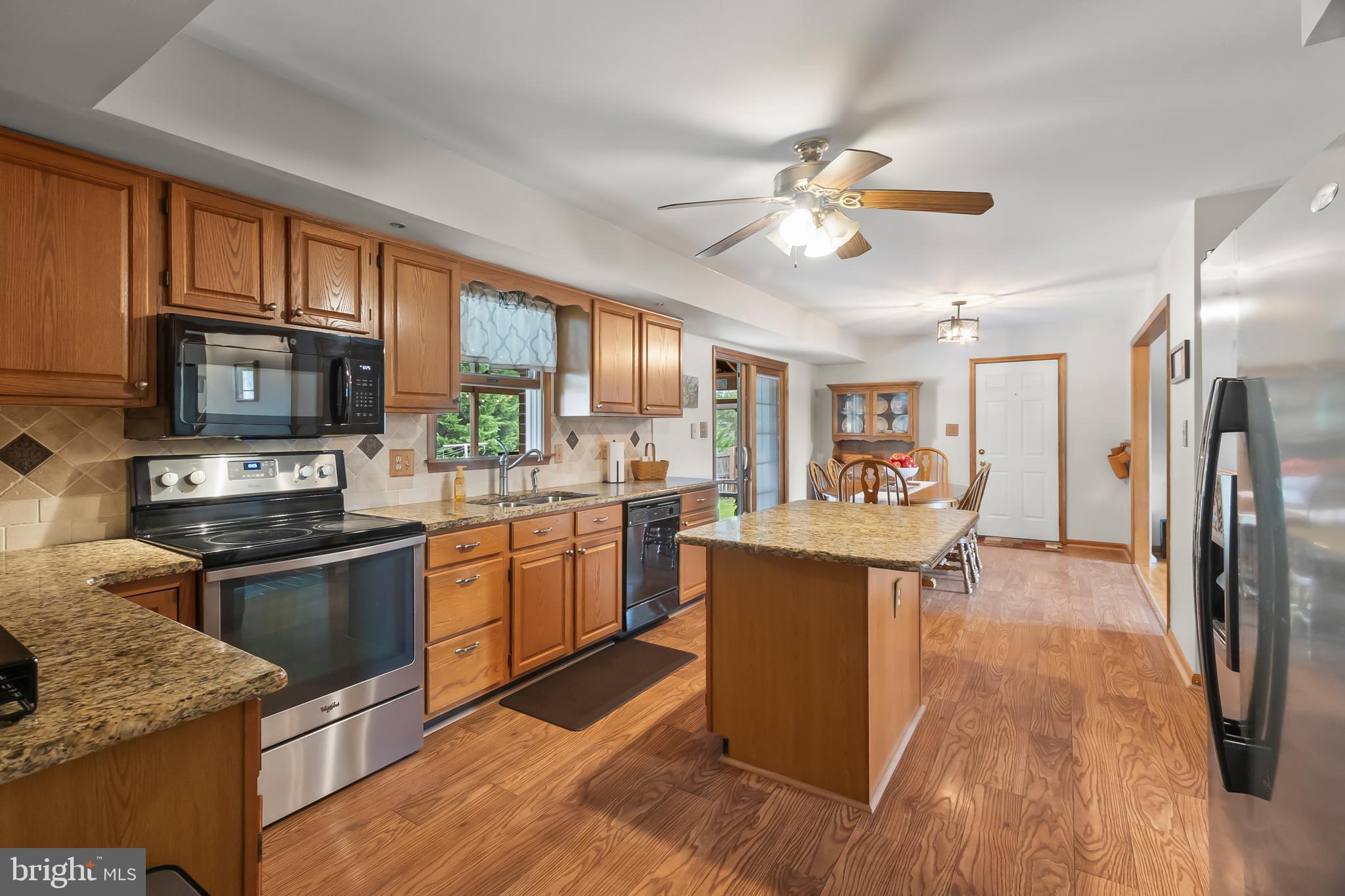 8 Wortham Court Bear, DE 19701 - Photo 18 of 71 a kitchen with stainless steel appliances granite countertop a refrigerator a stove top oven a sink dishwasher and white cabinets with wooden floor