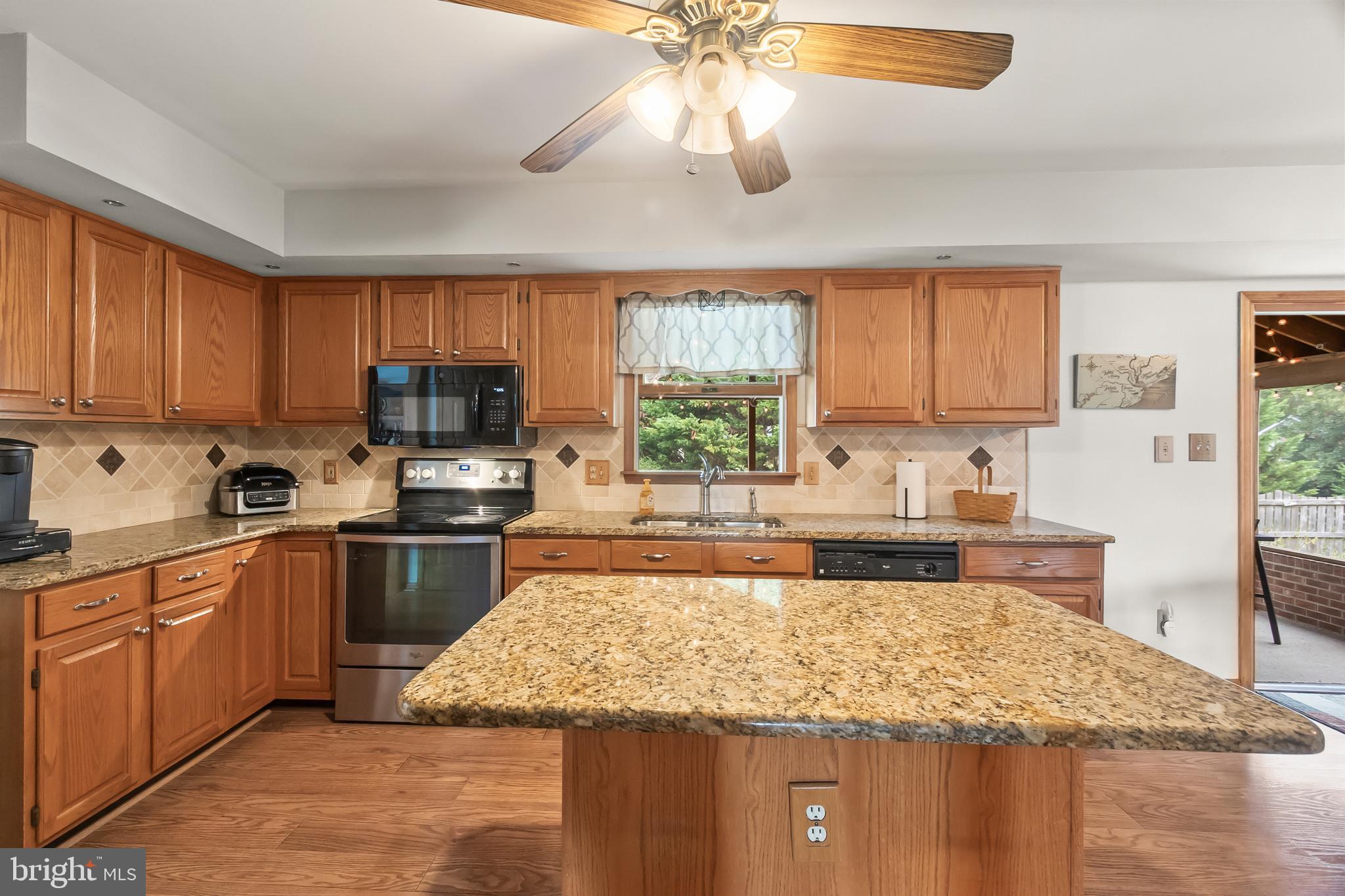 8 Wortham Court Bear, DE 19701 - Photo 19 of 71 a kitchen with kitchen island granite countertop stainless steel appliances a sink stove top oven and cabinets